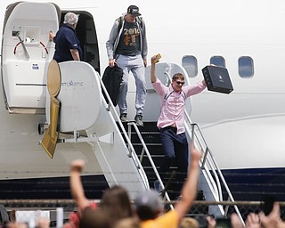 NBA champion Cleveland Cavaliers' Timofey Mozgov, right, celebrates as he arrives at the airport Monday, June 20, 2016, in Cleveland.  (AP Photo/John Minchillo)