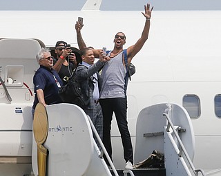 NBA champion Cleveland Cavaliers' Channing Frye, right, celebrates with teammates as they arrive at the airport Monday, June 20, 2016, in Cleveland.  (AP Photo/John Minchillo)
