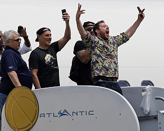 Cleveland Cavaliers' Matthew Dellavedova, from Australia, yells to fans after arriving in Cleveland, Monday, June 20, 2016. The Cavaliers defeated Golden State in Game 7 of the NBA Finals on Sunday in Oakland, Calif.(AP Photo/Tony Dejak)