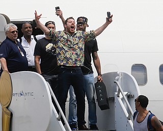 NBA champion Cleveland Cavaliers' Matthew Dellavedova, center, celebrates with teammates as they arrive at the airport Monday, June 20, 2016, in Cleveland. . (AP Photo/John Minchillo)