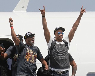 NBA champion Cleveland Cavaliers' Dahntay Jones, right, and Mo Williams celebrate as they arrive at the airport Monday, June 20, 2016, in Cleveland. (AP Photo/John Minchillo)
