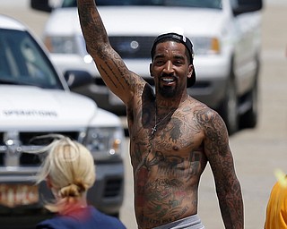 Cleveland Cavaliers' J.R. Smith waves to fans after arriving at the airport in Cleveland, Monday, June 20, 2016. The Cavaliers defeated Golden State in Game 7 of the NBA Finals on Sunday in Oakland, Calif.  (AP Photo/Tony Dejak)