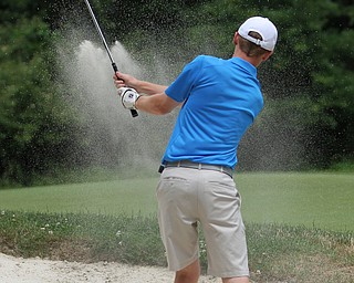 Nikos Frazier | The Vindicator..Keegan Butler, of Canfield, chips the ball out of a sand trap on hole 3.