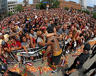 Cleveland Cavaliers' J.R. Smith is hugged by a fan before the start of a parade celebrating the Cleveland Cavaliers' NBA Championship in downtown Cleveland Wednesday, June 22, 2016. (AP Photo/Gene J. Puskar)