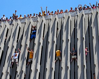 Cleveland Cavaliers fans watch from a parking garage as the car carrying Cavaliers' LeBron James passes during a parade celebrating the Cleveland Cavaliers' NBA Championship in downtown Cleveland Wednesday, June 22, 2016. (AP Photo/Gene J. Puskar)