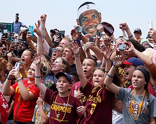 Cleveland Cavaliers fans react as the car carrying Cavaliers' LeBron James passes during a parade celebrating the Cleveland Cavaliers' NBA Championship in downtown Cleveland Wednesday, June 22, 2016. (AP Photo/Gene J. Puskar)