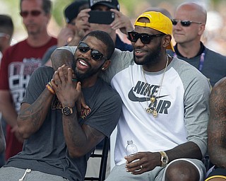 Cleveland Cavaliers' LeBron James, right, and Kyrie Irving hug during a rally Wednesday, June 22, 2016, in Cleveland. The Cavaliers made history by overcoming a 3-1 deficit to beat the Golden State Warriors in the NBA Finals and end the city's 52-year drought without a professional sports championship. (AP Photo/Tony Dejak)