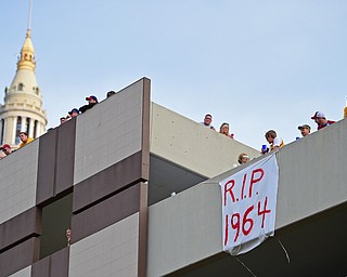 CLEVELAND, OHIO - JUNE 22, 2016: Cleveland fans display a banner from atop a parking deck Wednesday morning before the Cavaliers championship parade. DAVID DERMER | THE VINDICATOR