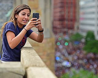 CLEVELAND, OHIO - JUNE 22, 2016: Maha Khouri of Cleveland, Ohio snaps a picture of the crowd on her cell phone from atop a parking deck on East 9th Street, Wednesday morning before the Cavaliers Championship Parade. DAVID DERMER | THE VINDICATOR