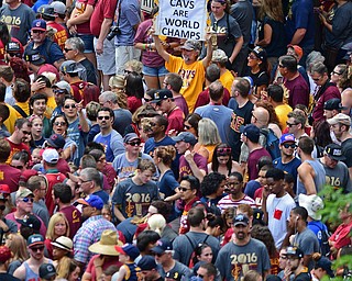 CLEVELAND, OHIO - JUNE 22, 2016: A Cleveland Indians fan holds up a sign celebrating the Cavaliers victory in a sea of people on East 9th Street, Wednesday morning before the Cavaliers championship parade. DAVID DERMER | THE VINDICATOR