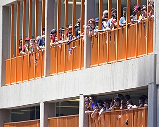 CLEVELAND, OHIO - JUNE 22, 2016: Cavaliers fans look out of a parking deck and toward East 9th Street while trying to get a good perspective for the Cavs Parade Wednesday afternoon. DAVID DERMER | THE VINDICATOR