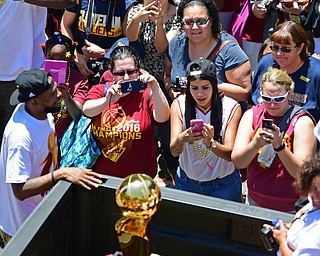 CLEVELAND, OHIO - JUNE 22, 2016: Cavaliers fans takes pictures of the Larry O'Brien NBA Championship Trophy as it is driven down East 9th Street during the Cavaliers Championship Parade Wednesday afternoon. DAVID DERMER | THE VINDICATOR