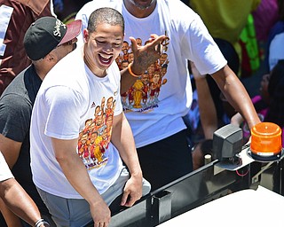CLEVELAND, OHIO - JUNE 22, 2016: Cleveland Cavaliers head coach Tyronn Lue smiles while hearing the fans cheers while riding in a truck bed with his assistant coaches down East 9th Street during the Cavaliers Championship Parade Wednesday afternoon. DAVID DERMER | THE VINDICATOR