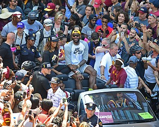 CLEVELAND, OHIO - JUNE 22, 2016: LeBron James smiles while fans scram his name and take pictures on their cell phones while he rides down East 9th Street during the Cavaliers Championship Parade Wednesday afternoon. DAVID DERMER | THE VINDICATOR