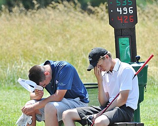 Jeff Lange | The Vindicator FRI, JUN 24. 2016 - With temperatures in the mid 80s, Boardman's Cole Christman (left) and Bobby Jonda wipe their brows as they take a break from the action before continuing to hole No. 12 during Friday's Greatest Golfer of the Valley Junior competition at Tam O'Shanter Golf Course in Hermitage, Pa.