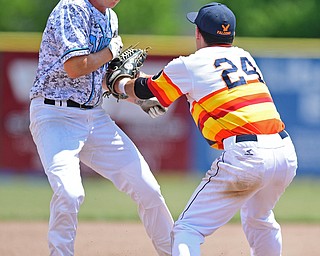 STRUTHERS, OHIO - JUNE 26, 2016: Third basemen Matt Gibson #24 of Astro (right) tags out Connor Romingo #11 of the Scurve for the out as he attempted to advance to third in the first inning of Sunday afternoons Bob Cene Tournament Championship game. Astro won 11-1. DAVID DERMER | THE VINDICATOR