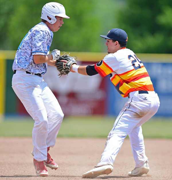 STRUTHERS, OHIO - JUNE 26, 2016: Third basemen Matt Gibson #24 of Astro (right) tags out Connor Romingo #11 of the Scurve for the out as he attempted to advance to third in the first inning of Sunday afternoons Bob Cene Tournament Championship game. Astro won 11-1. DAVID DERMER | THE VINDICATOR