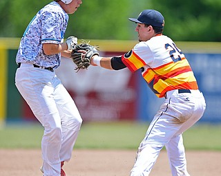 STRUTHERS, OHIO - JUNE 26, 2016: Third basemen Matt Gibson #24 of Astro (right) tags out Connor Romingo #11 of the Scurve for the out as he attempted to advance to third in the first inning of Sunday afternoons Bob Cene Tournament Championship game. Astro won 11-1. DAVID DERMER | THE VINDICATOR