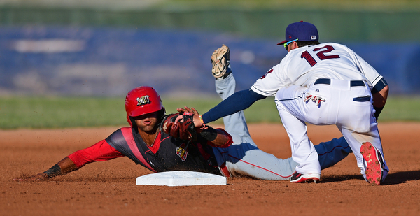 NILES, OHIO - JUNE 27, 2016: Second baseman Alexis Pantoja(12) of the Scrappers tags out base runner Kris Goodman(8) of the Muckdogs as he attempts to steal second base in the first inning of Monday nights game at Eastwood Field. DAVID DERMER | THE VINDICATOR