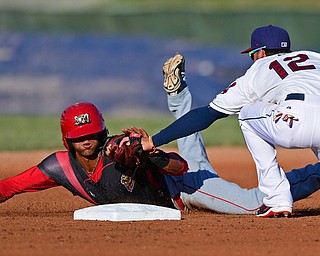 NILES, OHIO - JUNE 27, 2016: Second baseman Alexis Pantoja(12) of the Scrappers tags out base runner Kris Goodman(8) of the Muckdogs as he attempts to steal second base in the first inning of Monday nights game at Eastwood Field. DAVID DERMER | THE VINDICATOR