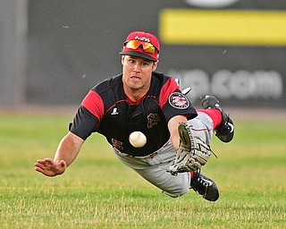 NILES, OHIO - JUNE 27, 2016: Center fielder Aaron Knapp(5) of the Muckdogs dives in an unsuccessful attempt to prevent a base hit by Grofi Cruz of the Scrappers in the fifth inning of Monday nights game at Eastwood Field. DAVID DERMER | THE VINDICATOR