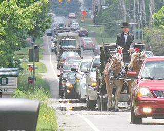 William D. Lewis The Vindicator Jim Best of Farmdale, owner of Best Horse Carriage, and his team of horses pull a hearse carrying the body of Bradford Baker along Rt 46 from Lane Funeral home to burial at Green Haven Memorial Park June 28, 2016. SEE VINDY OBIT FOR DEATAILS ABOUT MR. BAKER