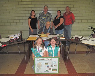 SPECIAL TO THE VINDICATOR
Three members of Girl Scout Troop 80777 of Columbiana are working to earn their bronze award. The bronze award is the first of three high level awards to reach the gold award. Girl Scouts participate in projects that leave a lasting impression on the community to earn the awards. These scouts are researching Fairfield Township history and are helping create signage for the new Headwaters Nature Trail that Fairfield Township trustees are creating on township property. Donations toward the project are welcome and may be made by calling Crystal Siembida Boggs, troop leader, at 330-482-9105, or Barry Miner with Fairfield Township. Kneeling in front, are Girl Scouts Elizabeth Siembida, left, and Katrina Kaszowski; sitting is Karl Garwood; and standing are Siembida Boggs; Bob Hum, troop co-leader; Kathy Kaszowski and Miner. Girl Scout Emily Smith also is working on the project.