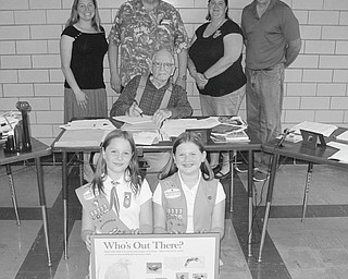 SPECIAL TO THE VINDICATOR
Three members of Girl Scout Troop 80777 of Columbiana are working to earn their bronze award. The bronze award is the first of three high level awards to reach the gold award. Girl Scouts participate in projects that leave a lasting impression on the community to earn the awards. These scouts are researching Fairfield Township history and are helping create signage for the new Headwaters Nature Trail that Fairfield Township trustees are creating on township property. Donations toward the project are welcome and may be made by calling Crystal Siembida Boggs, troop leader, at 330-482-9105, or Barry Miner with Fairfield Township. Kneeling in front, are Girl Scouts Elizabeth Siembida, left, and Katrina Kaszowski; sitting is Karl Garwood; and standing are Siembida Boggs; Bob Hum, troop co-leader; Kathy Kaszowski and Miner. Girl Scout Emily Smith also is working on the project.