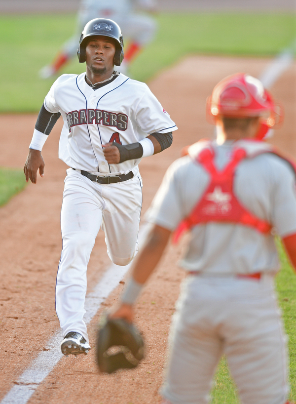 NILES, OHIO - JUNE 28, 2016: Base runner Erlin Cerda(4) of the Scrappers runs home to score on a sacrifice fly by Jodd Carter in the fifth inning of Tuesday nights game at Eastwood Field. DAVID DERMER | THE VINDICATOR