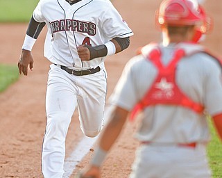NILES, OHIO - JUNE 28, 2016: Base runner Erlin Cerda(4) of the Scrappers runs home to score on a sacrifice fly by Jodd Carter in the fifth inning of Tuesday nights game at Eastwood Field. DAVID DERMER | THE VINDICATOR