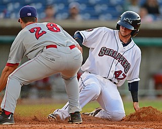 NILES, OHIO - JUNE 28, 2016: Base runner Logan Ice(47) of the Scrappers slides across home to score a run beating the tag from pitcher Nicholas Conner(26) of the Doubledays after a wild pitch in the sixth inning of Tuesday nights game at Eastwood Field. DAVID DERMER | THE VINDICATOR