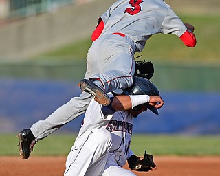 Paul Gonzalez(16) of the Scrappers takes a knee to the head from Clayton Brandt(3) of the Doubledays while he flies though the air. The injury on the play would knock Gonzalez out of the game.  DAVID DERMER | THE VINDICATOR.