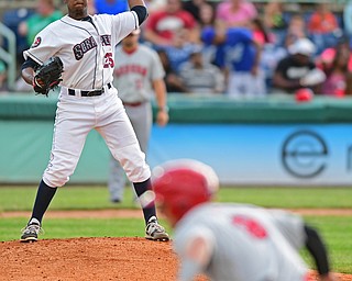 Starting pitcher Juan Hillman(25) of the Scrappers throws to first in an attempt to pick off Paul Panaccione(9) of the Doubledays in the fourth inning of Wednesday nights game at Eastwood Field. DAVID DERMER | THE VINDICATOR.