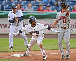Erlin Cerda(4) of the Scrappers waits for the umpires call while calling himself safe after a RBI triple and beating a tag from Doubledays Sheldon Neuse(38) in the fifth inning of Wednesday nights game at Eastwood Field. DAVID DERMER | THE VINDICATOR.