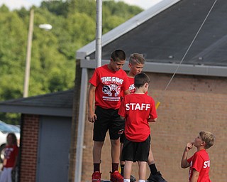 Nikos Frazier | The Vindicator..Kids play on a rock at Springfield High School in New Middleton before the 2016 Battle of the Border.