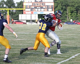 Nikos Frazier | The Vindicator..Pennsylvania's Payton Rusienello(32) attempts to take down Ohio's Jeremy Gorby(84) in the first quarter of the 2016 Battle of the Border at Springfield High School in New Middleton.