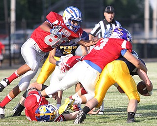 Nikos Frazier | The Vindicator..Pennsylvania's Payton Rusienello(bottom right) is taken town by Ohio's Josh Liberati(3) as Greg Brunner(86) dives in assistance in the first quarter of the 2016 Battle of the Border at Springfield High School in New Middleton.