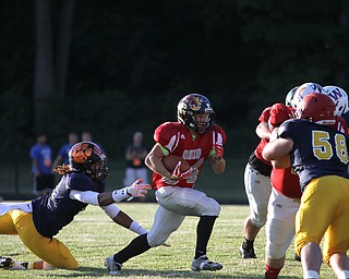 Nikos Frazier | The Vindicator..Ohio's Zack Hicks(34) narrowly dodges Pennsylvania's Malique Whaley(11) in the first half of the 2016 Battle of the Border at Springfield High School in New Middleton.