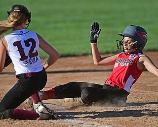 BOARDMAN, OHIO - JUNE 30, 2016: Base runner Hayden Merritt(21) of Canfield steals third base beating a tag from Gina Sferra(12) of Boardman, in the third inning of their District 2 softball championship game at the Field of Dreams. DAVID DERMER | THE VINDICATOR