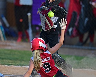 BOARDMAN, OHIO - JUNE 30, 2016: Catcher Gia Triueri(11) of Boardman, looses the ball while runner Carlie Harmon(9) of Canfield slides into home to score a run in the fifth inning of their District 2 softball championship game at the Field of Dreams. DAVID DERMER | THE VINDICATOR