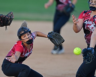 BOARDMAN, OHIO - JUNE 30, 2016: Third baseman Emma Castronova(23) of Canfield lunges for the ball after pitcher Lauren Fitzgerald(32) tipped it away from her in the second inning of their District 2 softball championship game at the Field of Dreams. DAVID DERMER | THE VINDICATOR