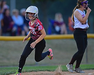 BOARDMAN, OHIO - JUNE 30, 2016: Runner Parker Wilkins(14) of Canfield rounds third base to head home and score a run on a hit by Lauren Fitzgerald(32) in the third inning of their District 2 softball championship game at the Field of Dreams. DAVID DERMER | THE VINDICATOR
