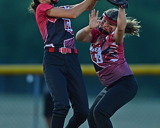 BOARDMAN, OHIO - JUNE 30, 2016: Third baseman Emma Castronova(23) and short stop Mia Opalick(13) of Canfield collide while going after a fly ball in the fourth inning of their District 2 softball championship game at the Field of Dreams. DAVID DERMER | THE VINDICATOR