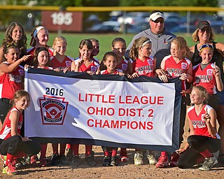 BOARDMAN, OHIO - JUNE 30, 2016: The players and coaches for the 9/10 year old Canfield softball team hold up their championship banner after defeating Boardman Thursday evening at the Field of Dreams. DAVID DERMER | THE VINDICATOR