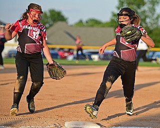 BOARDMAN, OHIO - JUNE 30, 2016: Third baseman Emma Castronova(23) of Canfield steps on third base to force out a Boardman base runner after fielding a ground ball in the first inning of their District 2 softball championship game at the Field of Dreams. DAVID DERMER | THE VINDICATOR..Short stop Mia Opalick #13 pictured.