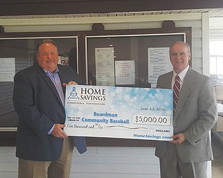 SPECIAL TO THE VINDICATOR
Home Savings Charitable Foundation recently donated $5,000 to Boardman Community Baseball to support a patio pavilion project at BCB’s Field of Dreams. The roof of a 22-year-old administration building also will be re-shingled. The project will provide a covered seating and standing area adjacent to the concession stand to protect spectators from the elements while watching games. Rick Schafer, left, BCB board member, recently accepted the donation from Ken Goldsboro, commercial relationship manager for Home Savings. For information about BCB, call 330-758-2123 or visit boardmanbaseball.com.