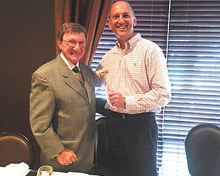SPECIAL TO THE VINDICATOR
Above left, a new president takes them helm of the Youngstown Lions Club. Kyle Miasek, right, deputy director of finance of Youngstown, receives the gavel from outgoing president George Kolesar. Below right, Past District Governor Bob Booher, right, presents Lioness Jeanne Watson-Antol of Home Savings and Loan with the Melvin Jones Fellowship Award, the highest form of recognition for service bestowed by the Lions Club International Foundation. Booher also installed new officers and board of directors at the Youngstown Lions Club meeting June 23 at the Upstairs Restaurant in Austintown.