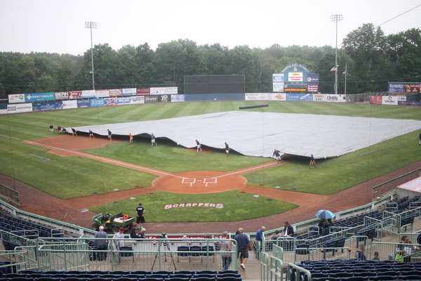 Nikos Frazier | The Vindicator..Eastwood Field grounds crew covers the diamond with a tarp on July 4, 2016 before the Scrappers took on the Lake Monsters.