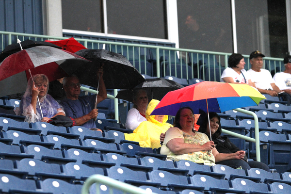 Nikos Frazier | The Vindicator..Scrapper fans take refuge under umbrellas as a light rain delayed the Scrappers from playing the Lake Monsters.