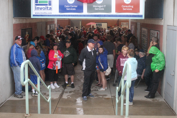 Nikos Frazier | The Vindicator..Fans take refuge in a breezeway during a short rain delay on July 4, 2016.